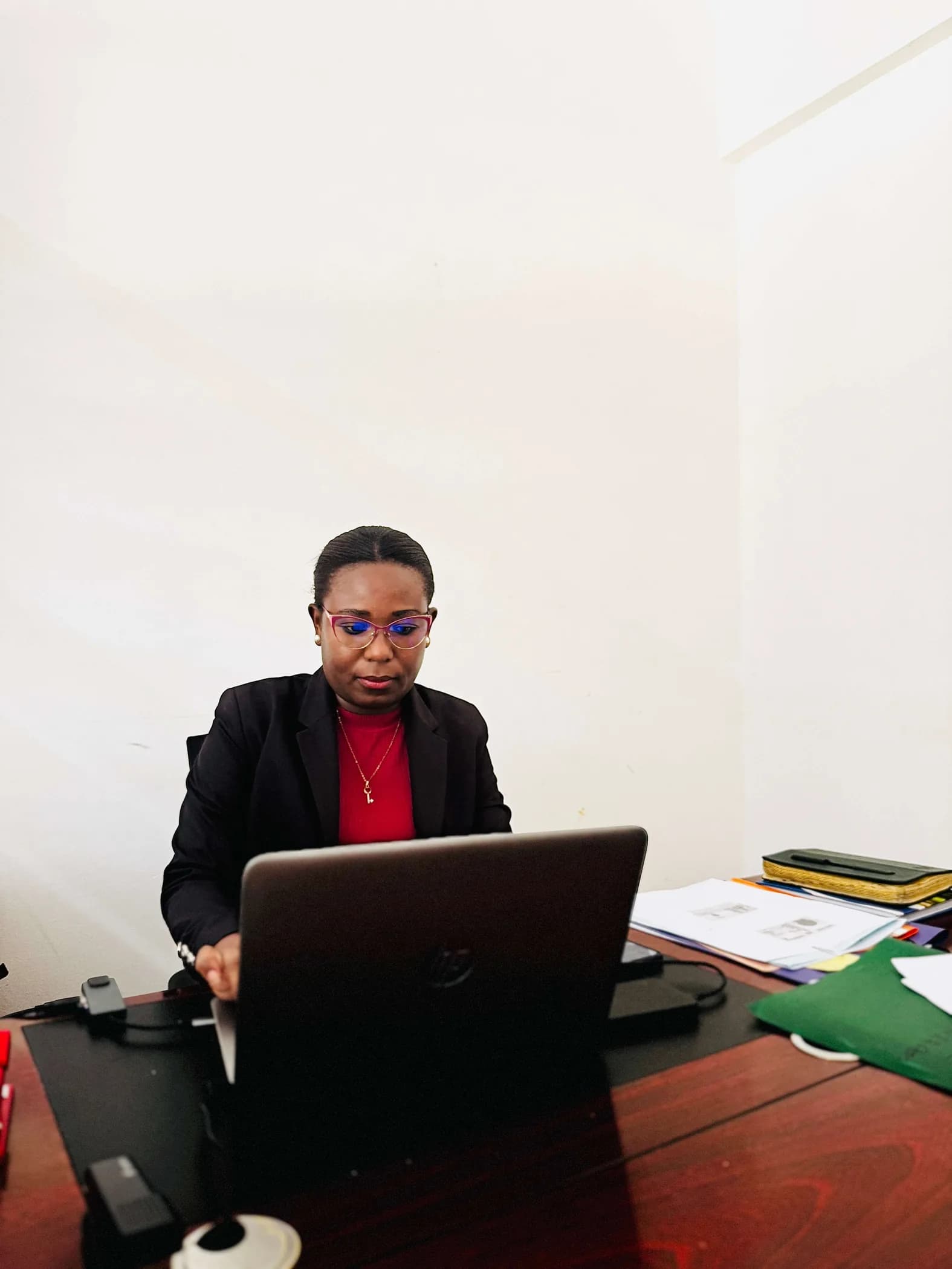 Adoyo J working at her desk in the firm's office in Malindi